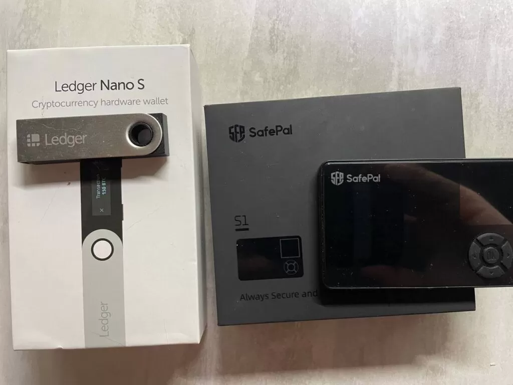 Safepal and Ledger Nano crypto wallets on the original boxes
